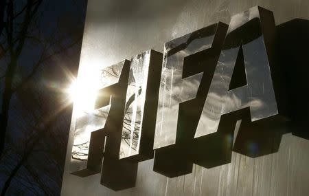 The sun is reflected in FIFA's logo in front of FIFA's headquarters in Zurich, Switzerland November 19, 2015. REUTERS/Arnd Wiegmann