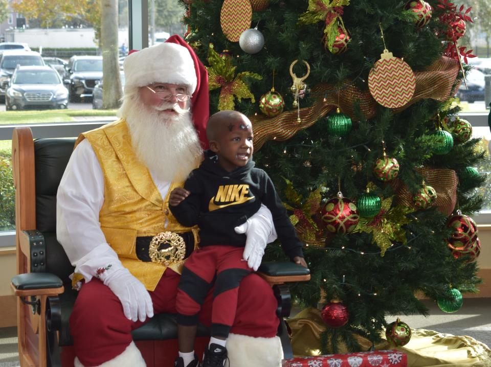 Isaiah King, a Georgia patient at the UF Health Proton Therapy Institure in Jacksonville, gets personal time with "Santa" Joe McGee, who was treated at the center himself in 2012. [Provided by UF Health Proton Therapy Institute]