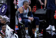 Washington Wizards guard Russell Westbrook (4) watches from the bench during the second half of an NBA basketball game against the Phoenix Suns, Saturday, April 10, 2021, in Phoenix. (AP Photo/Matt York)