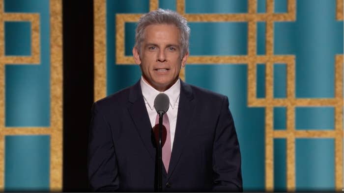 Ben Stiller speaking on stage in a suit and tie