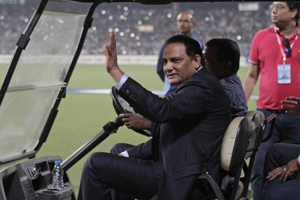 Former Indian cricketer Mohammad Azharuddin acknowledges the crowd during a grand parade of India's former cricket captains during the first day of the second test match between India and Bangladesh, in Kolkata, India, Friday, Nov. 22, 2019. (AP Photo/Bikas Das)