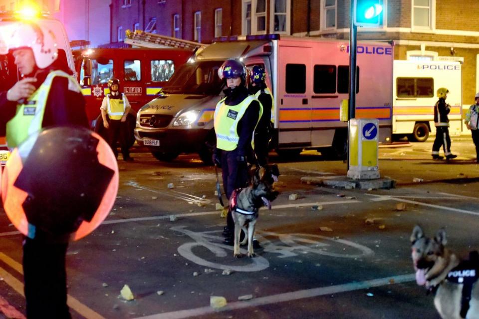 Clashes: Police on the scene in east London (PA)