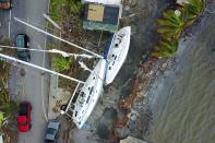 <p>Damaged sail boats washed ashore are seen in the aftermath of Hurricane Maria in Fajardo, Puerto Rico, Thursday, Sept. 21, 2017. (Photo: Ricardo Arduengo/AFP/Getty Images) </p>