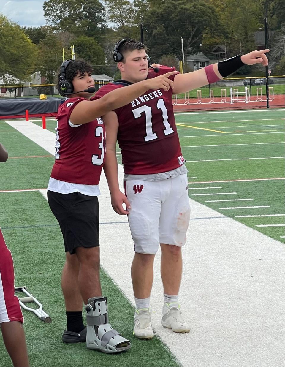 Westborough seniors Sebastian Grillo, left, and Joe Marino put on head sets during the team's 43-6 win over Fitchburg on Oct. 14, 2023.