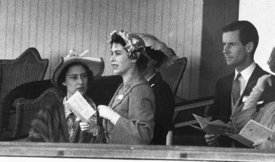 Princess Margaret, Princess Elizabeth, and Group Captain Peter Townsend gather June 13, 1951 in the Royal Box at Ascot.
