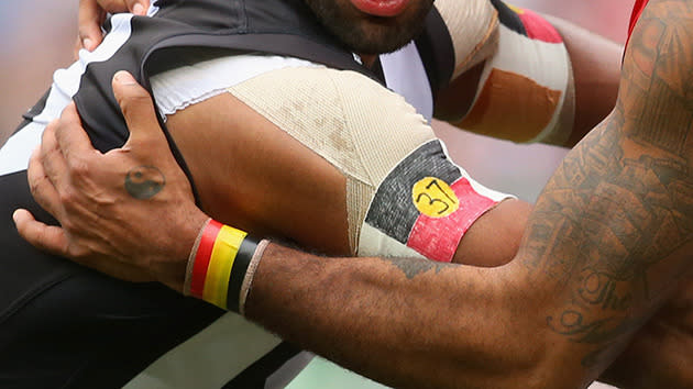 Players wear Aboriginal flags and the number 37 for Adam Goodes.