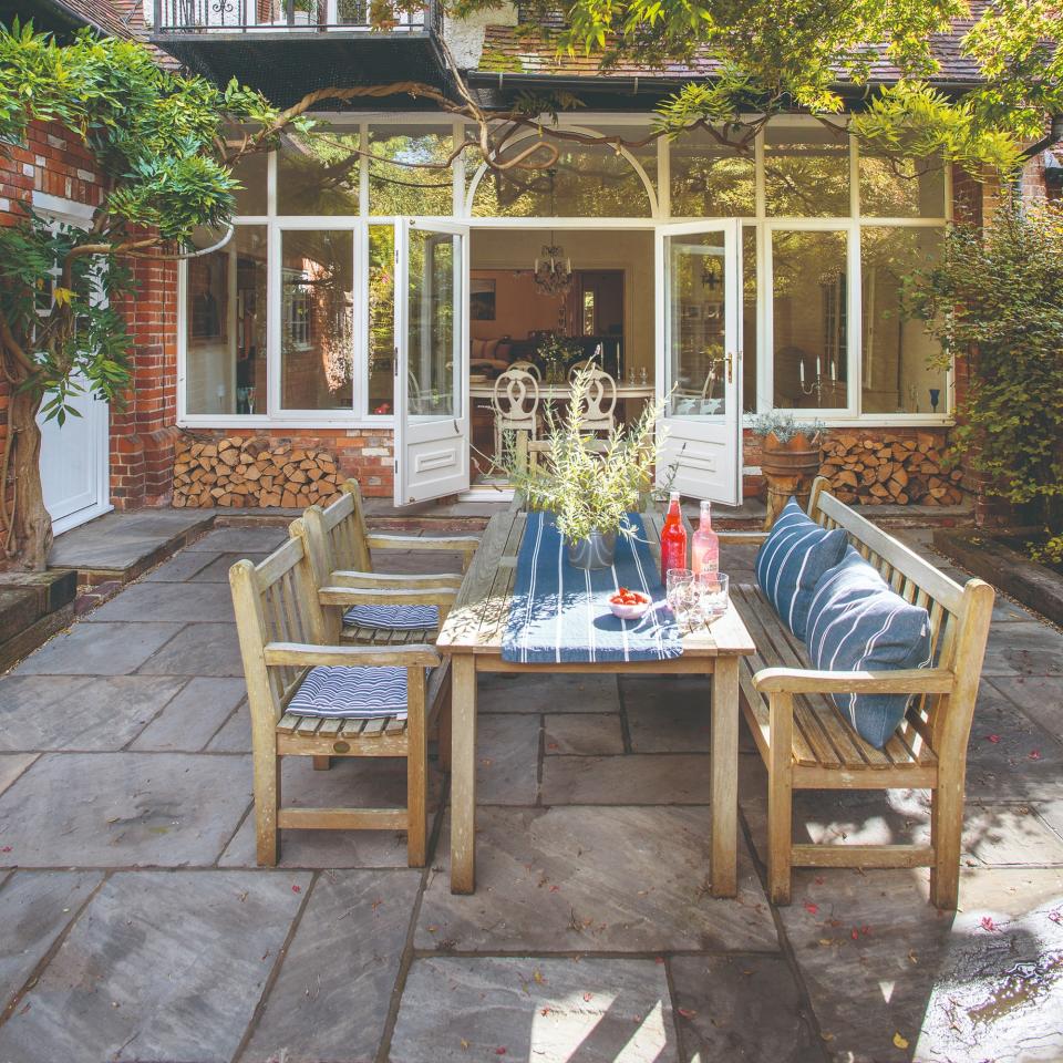 An outdoor seating area with a house in the background