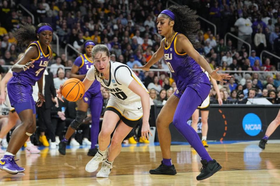 Iowa Hawkeyes guard Kate Martin (20) controls the ball against LSU Lady Tigers forward Angel Reese (10) in the second quarter in the finals of the Albany Regional in the 2024 NCAA Tournament at MVP Arena. Mandatory Credit: Gregory Fisher-USA TODAY Sports