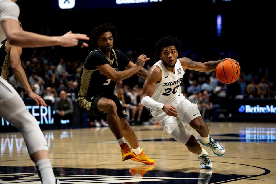 Xavier Musketeers guard Dayvion McKnight (20) drives on Bryant Bulldogs guard Sherif Gross-Bullock (3) in the second half of the NCAA basketball game Bryant Bulldogs and Xavier Musketeers at Cintas Center in Cincinnati on Friday, Nov. 24, 2023.