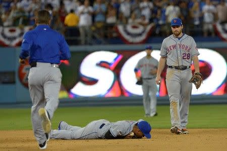 Oct 10, 2015; Los Angeles, CA, USA; New York Mets shortstop Ruben Tejada (center) reacts after an injury on a collision at second base during the seventh inning in game two of the NLDS against the Los Angeles Dodgers at Dodger Stadium. Mandatory Credit: Jayne Kamin-Oncea-USA TODAY Sports