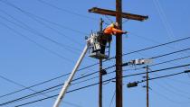 A man works on power lines in Los Angeles, California on May 4, 2020, amid the coronavirus pandemic. - California governor Gavin Newsom earlier today announced the gradual reopening of the state later this week as dismal US employment figures are expected with the release of figures Friday May 8 for April's US jobs report, as 30 million Americans filed for unemployment in the last six weeks. (Photo by Frederic J. BROWN / AFP) (Photo by FREDERIC J. BROWN/AFP via Getty Images)