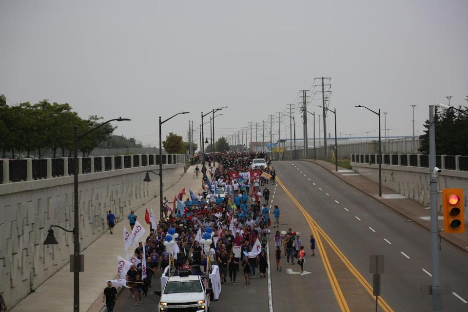 Union workers march down Walker Rd. past the Stellantis plant in the 2022 Labour Day Parade in Windsor. The 2022 parade was the first parade since 2019.