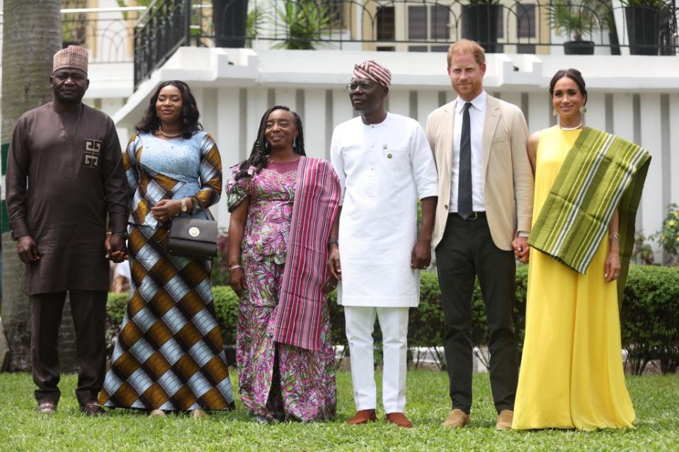 Nigeria Chief of Defense Staff Christopher Musa (L), his wife Lilian Musa (2ndL), Lagos State Governor wife, Ibijoke Sanwo-Olu (3rdL), Lagos State Governor, Babajide Sanwo-Olu (3ndR), Britain’s Prince Harry (2ndR), Duke of Sussex, and Britain’s Meghan (R), Duchess of Sussex, pose for a photo at the State Governor House in Lagos on May 12, 2024 as they visit Nigeria as part of celebrations of Invictus Games anniversary. AFP via Getty Images