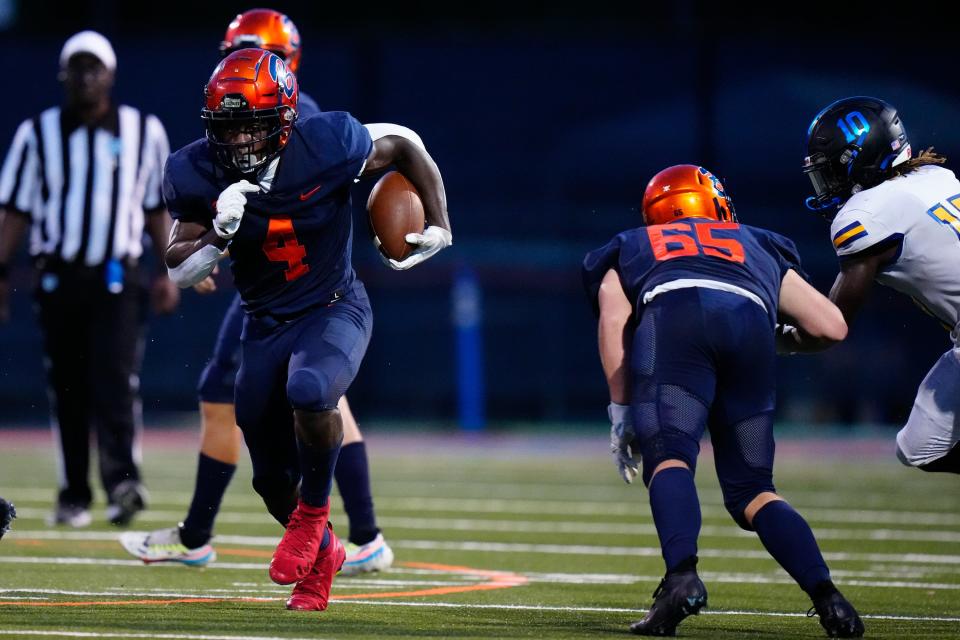 Benjamin High School’s running back Chauncey Bowens (4) runs the ball against John Carroll Catholic in a high school football game on Thursday, Aug. 25, 2022 at Benjamin High School in Palm Beach. John Carroll won 24-21.