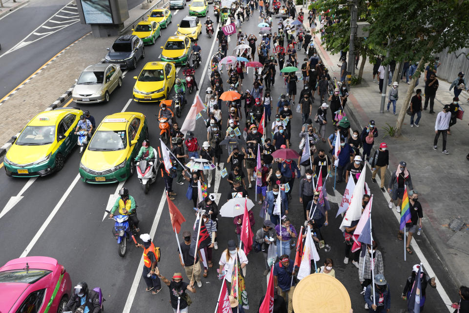 Pro-democracy supporters wearing face mask march on the road during a demonstration in Bangkok, Thailand, Thursday, June 24, 2021. Anti-government protests expected to resume in Bangkok after a long break due partly to a surge in COVID-19 cases. Gatherings are planned for several locations across the capital, despite health officials mulling a week-long lockdown in Bangkok to control a rampant virus surge. (AP Photo/Sakchai Lalit)