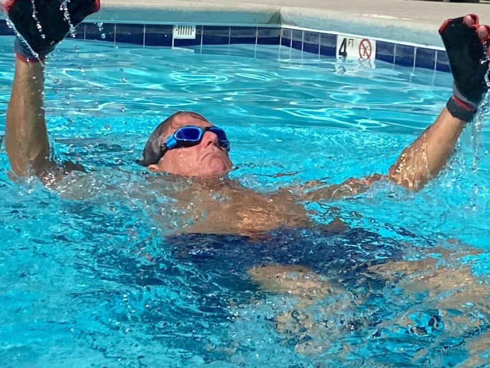 Ed Petner, a paraplegic since being hit by a car in 2003, swims a mile in his Clayton pool, part of his goal to reach 20 miles and raise $25,000 in support of research for the Christopher Reeve Foundation.