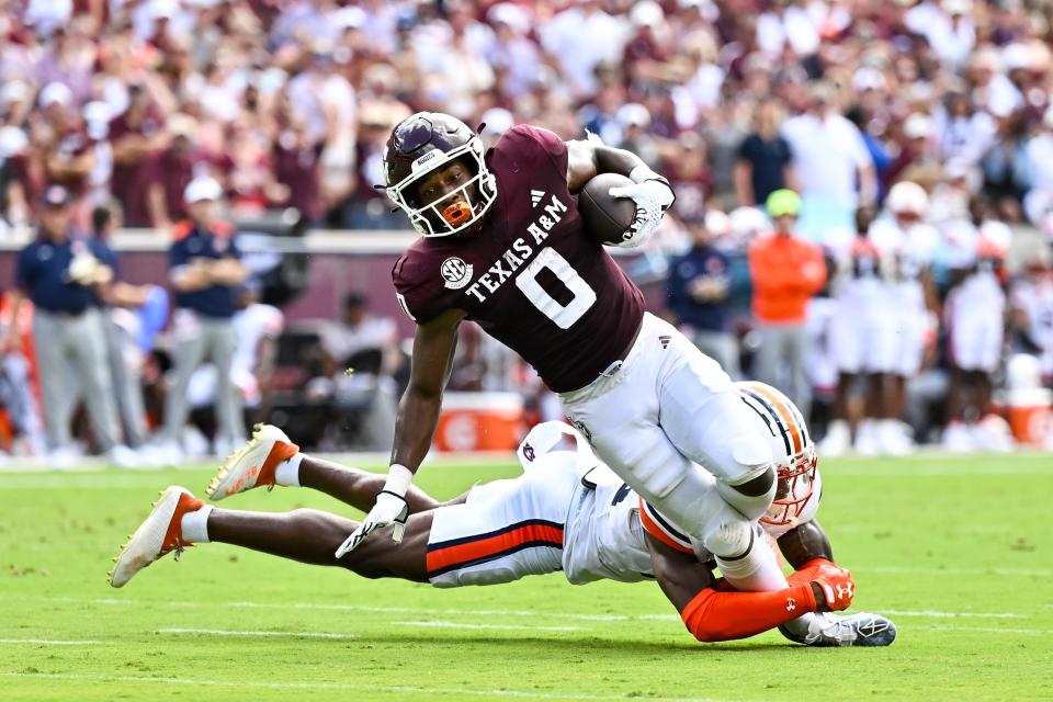 Sep 23, 2023; College Station, Texas; Auburn Tigers cornerback Jaylin Simpson (36) tackles Texas A&M Aggies wide receiver Ainias Smith (0) during the first quarter at Kyle Field. Maria Lysaker-USA TODAY Sports