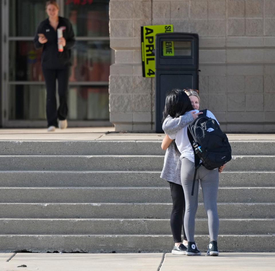 Dawn Wankowski (facing), an assist professor in biology at Cardinal Stritch for 21 years hugs a student outside the student union at Cardinal Stritch University in Fox Point on Tuesday. The school’s president announced Monday it would be closing its doors at the end of the spring semester.