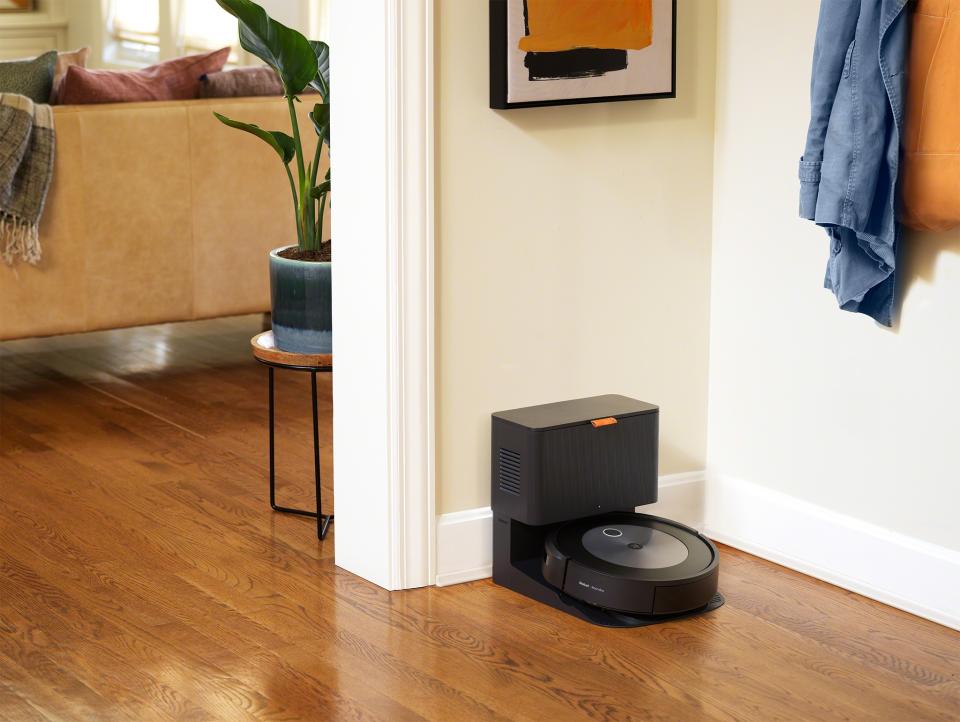 Image of iRobot Roomba j7+ docked in its clean base inside a modern home