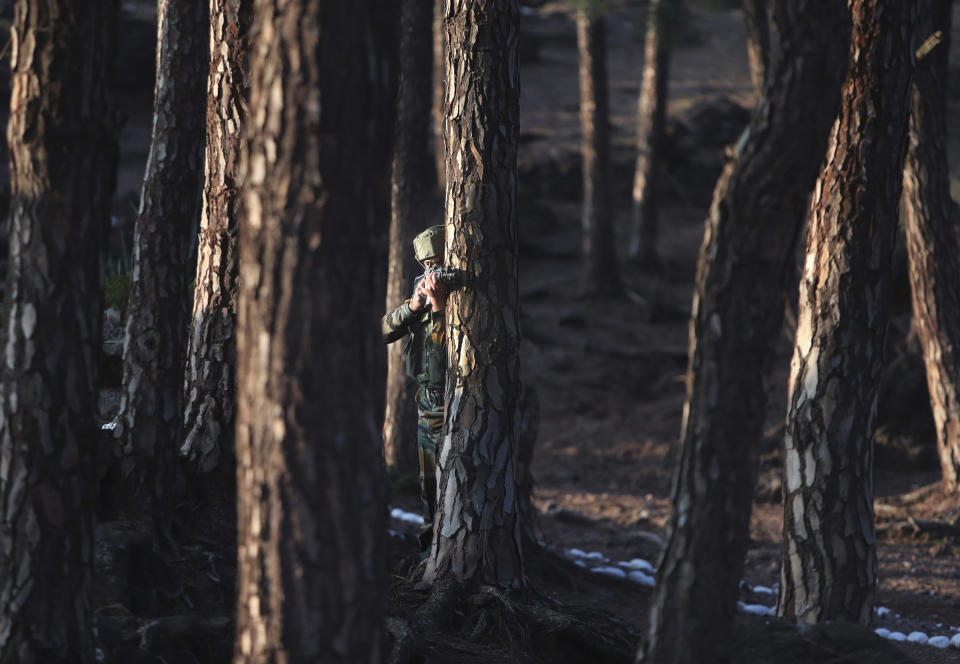 Indian army soldiers perform a cordon and search operation (CASO) during a training session at a corps battle school at Sarol in Rajouri, about 135 kilometers (84 miles) northwest of Jammu, India, Tuesday, Dec. 15, 2020. AP journalists were recently allowed to cover Indian army counterinsurgency drills in Poonch and Rajouri districts along the Line of Control. The training focused on tactical exercises, battle drills, firing practice, counterinsurgency operations and acclimatization of soldiers to the harsh weather conditions. (AP Photo/Channi Anand)
