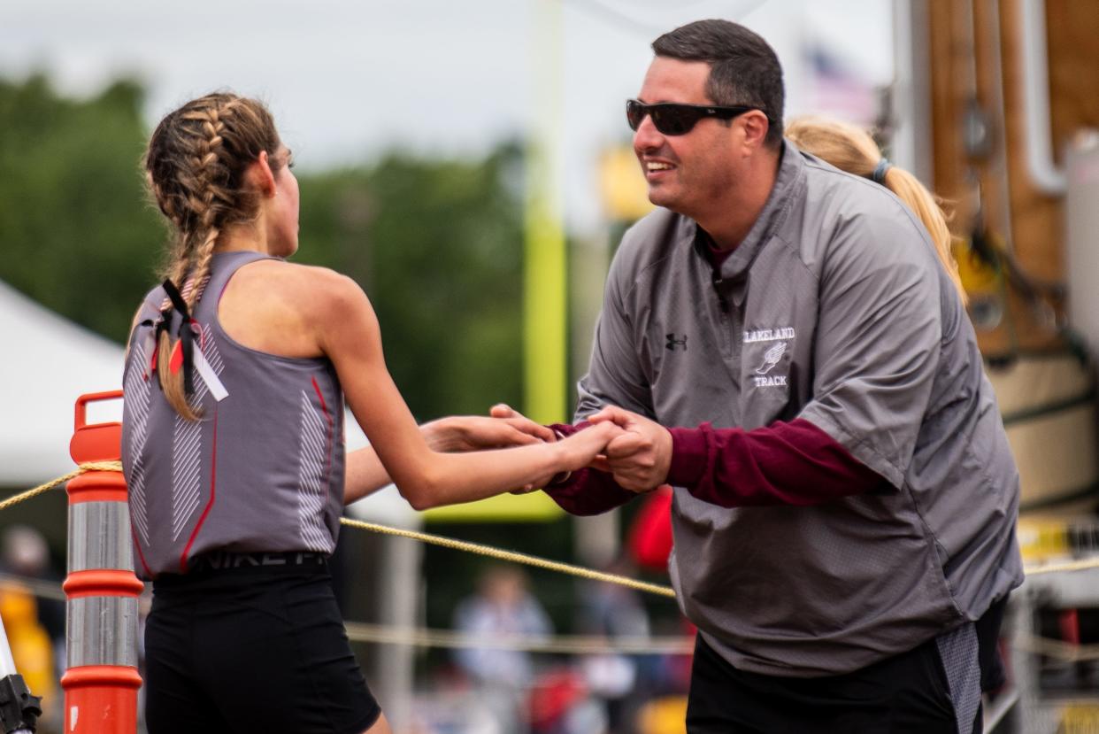 The track and field Meet of Champions is held at Franklin High School in Somerset, NJ on Saturday June 18, 2022. Lakeland track coach Damiano Conforti congratulates Lakeland's Angelina Perez for winning the 3200 meter run. 