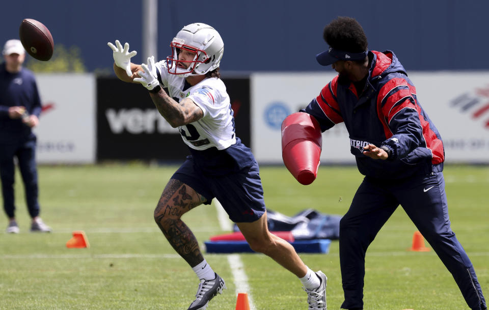 New England Patriots wide receiver tryout Beeau Corrales, left, runs through offensive drills during the NFL football team's rookie minicamp Saturday, May 11, 2024, in Foxborough, Mass. (AP Photo/Mark Stockwell)
