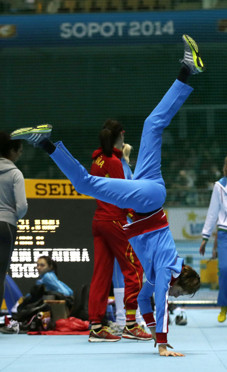 Croatia's Blanka Vlasic does a handstand as she warms up for the women's high jump qualification during the Athletics Indoor World Championships in Sopot, Poland, Friday, March 7, 2014. (AP Photo/Matt Dunham)