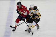 Florida Panthers center Aleksander Barkov (16) and Boston Bruins right wing David Pastrnak (88) go after the puck during the second period of Game 4 of an NHL hockey Stanley Cup first-round playoff series, Sunday, April 23, 2023, in Sunrise, Fla. (AP Photo/Marta Lavandier)