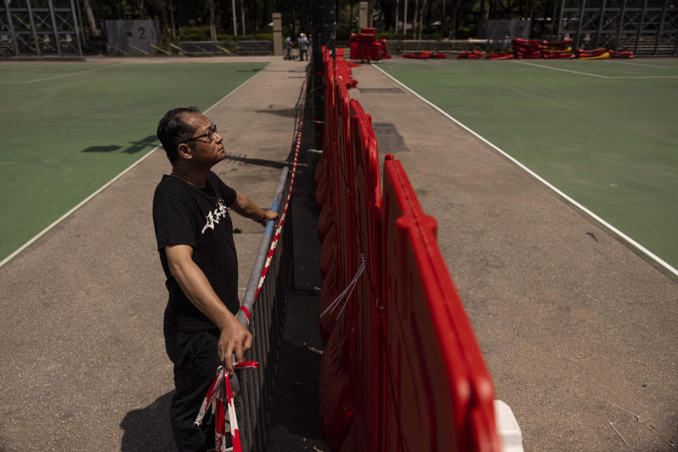 Richard Tsoi, former leader of now-disbanded Hong Kong Alliance in Support of Patriotic Democratic Movements of China, poses for photographs next to a closed pitch at Victoria Park in Hong Kong, Monday, May 29, 2023. As the 34th anniversary of China’s Tiananmen Square crackdown approaches Sunday, June 4, many in Hong Kong are trying to mark the day in their own ways in the shadow of a law that prosecuted many leading activists in the city’s pro-democracy movement. (AP Photo/Louise Delmotte)