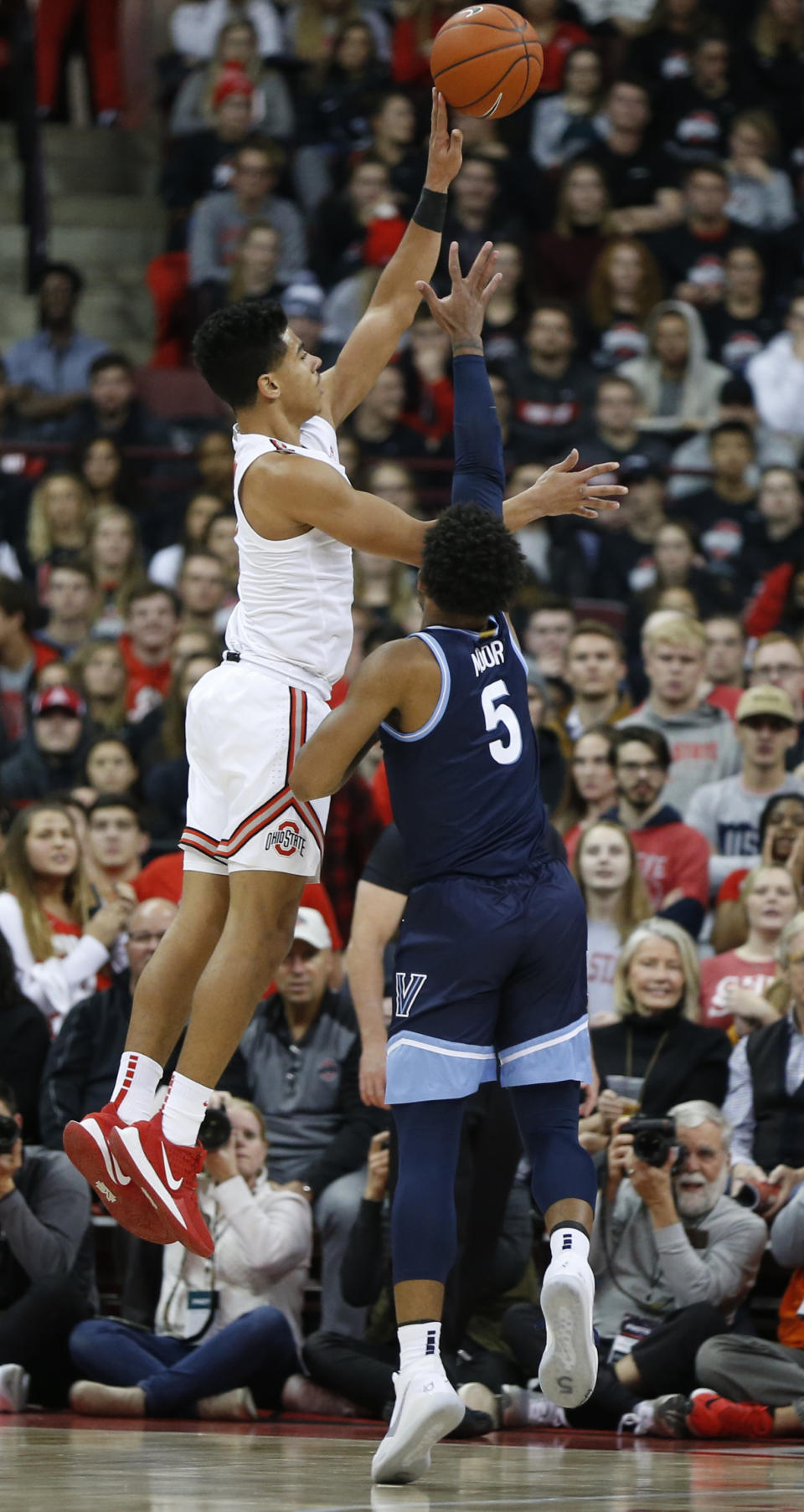 Ohio State's D.J. Carton, left, shoots over Villanova's Justin Moore during the first half of an NCAA college basketball game Wednesday, Nov. 13, 2019, in Columbus, Ohio. (AP Photo/Jay LaPrete)