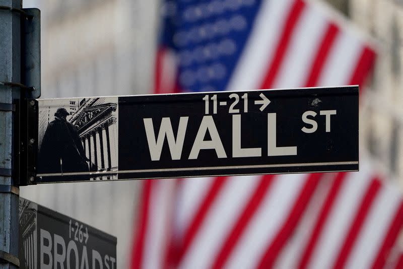 FILE PHOTO: The Wall Street sign is pictured at the New York Stock exchange (NYSE) in New York City, United States