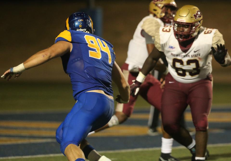 Angelo State University defensive tackle Weston Bauer, 94, tries to get to the quarterback during a game against Midwestern State earlier in the 2021 season. Bauer is a former Brady High School standout.