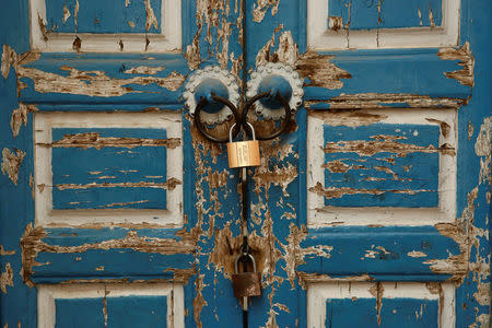 The locked door of a neighbourhood mosque is seen in Kashgar, Xinjiang Uighur Autonomous Region, China, March 23, 2017. REUTERS/Thomas Peter