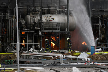 Firefighters spray water at a refinery after a fire broke out following an explosion in Vohburg near Ingolstadt, Germany, September 1, 2018. REUTERS/Andreas Gebert