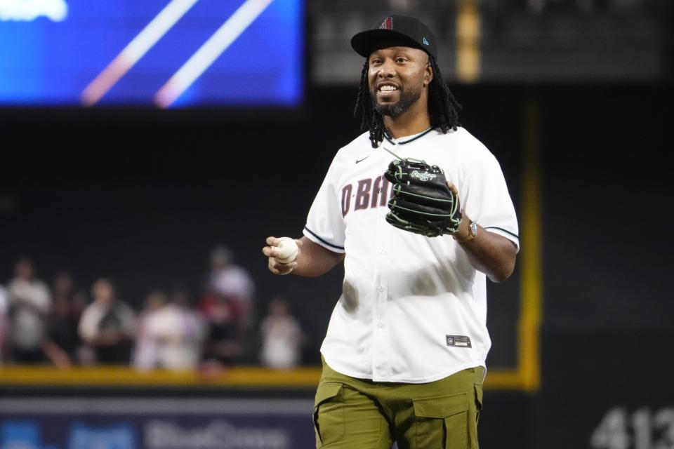 Former Arizona Cardinals receiver Larry Fitzgerald Jr. prepares to throw out the ceremonial first pitch before game four of the NLCS of the 2023 MLB playoffs between the Diamondbacks and the Philadelphia Phillies at Chase Field in Phoenix on Oct. 20, 2023.