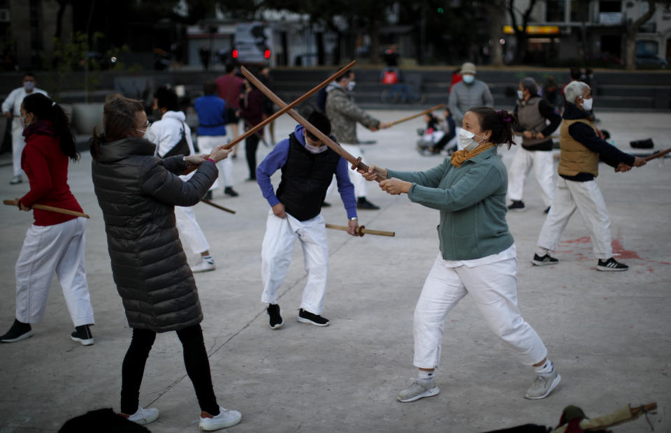 People practice aikido at a park amid the COVID-19 pandemic in Buenos Aires, Argentina, Wednesday, June 2, 2021. (AP Photo/Natacha Pisarenko)