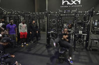 House of Athlete Scouting Combine founder and former NFL player Brandon Marshall, right foreground, is congratulated by Isaiah Ross after Marshall completed a series of bench presses for the combine participants on the second day of the House of Athlete Scouting Combine, Thursday, March 4, 2021, in Weston, Fla. (AP Photo/Wilfredo Lee)