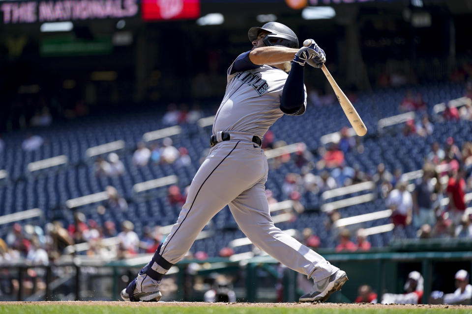 Seattle Mariners' Eugenio Suarez hits a three-run home run in the first inning of the first game of a baseball doubleheader against the Washington Nationals, Wednesday, July 13, 2022, in Washington. (AP Photo/Patrick Semansky)