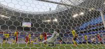 <p>England’s Harry Maguire scores the opening goal past Sweden goalkeeper Robin Olsen </p>