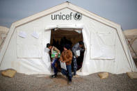 Displaced Iraqi boys leave a tent school set by United Nations Children's Fund (UNICEF) at Hassan Sham camp, east of Mosul, Iraq December 8, 2016. REUTERS/Mohammed Salem