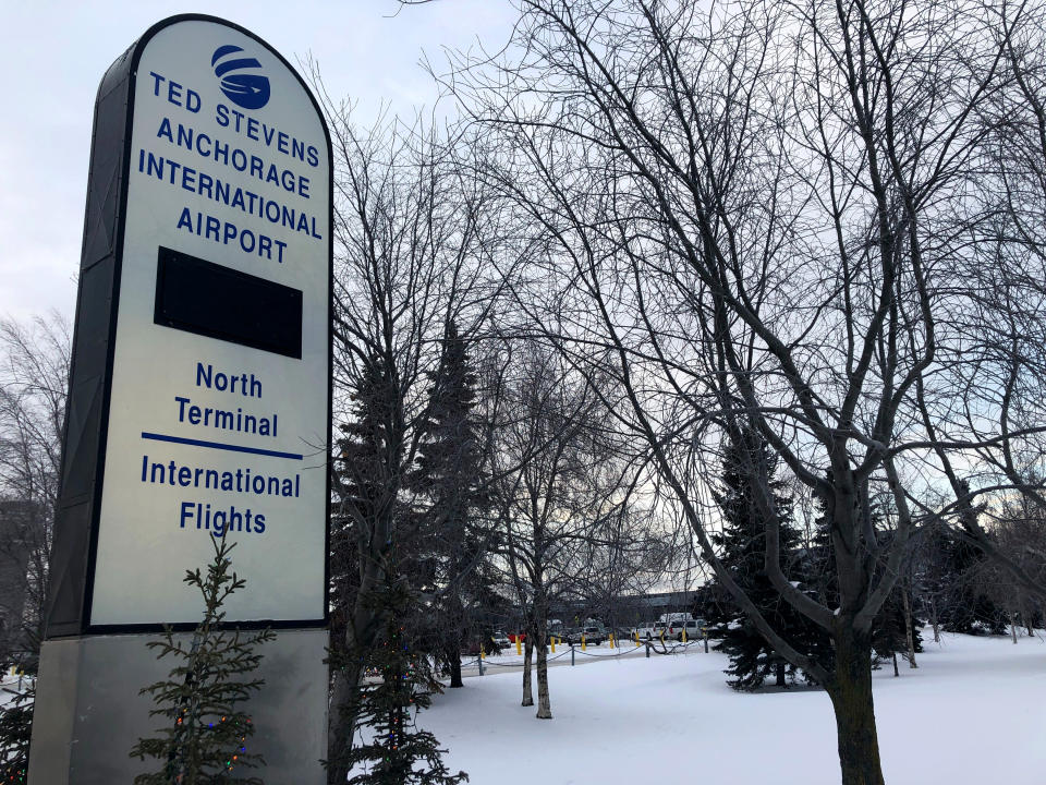 A sign directs travelers to the north terminal at Ted Stevens Anchorage International Airport in Anchorage, Alaska, where a flight plane carrying U.S. citizens being evacuated from Wuhan, China is expected later Tuesday, is seen Tuesday, Jan. 28, 2020. (AP Photo/Mark Thiessen)