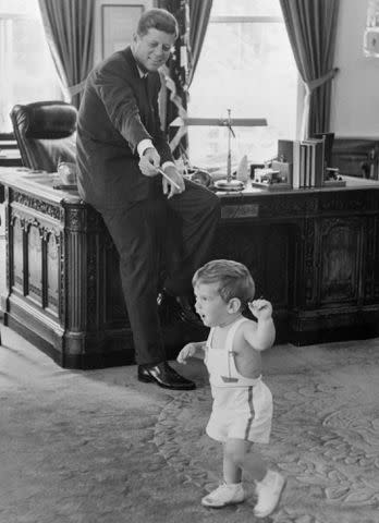 <p>Bettmann</p> John F. Kennedy with his son John F. Kennedy Jr. in the Oval Office.