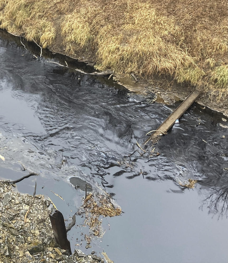 Oil from a Keystone pipeline rupture flows into Mill Creek in Washington County, Kansas, on Thursday, Dec 8, 2022. Vacuum trucks, booms and an emergency dam were constructed on the creek to intercept the spill. (Kyle Bauer/KCLY/KFRM Radio via AP)