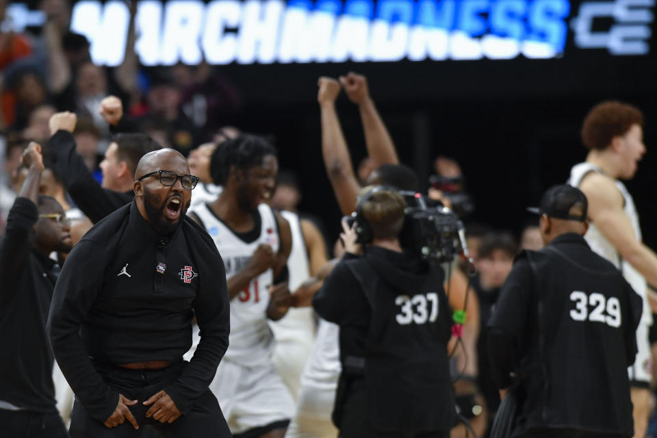 The San Diego State bench celebrates victory over Creighton after a Elite 8 college basketball game in the South Regional of the NCAA Tournament, Sunday, March 26, 2023, in Louisville, Ky. San Diego State won 57-56.(AP Photo/Timothy D. Easley)