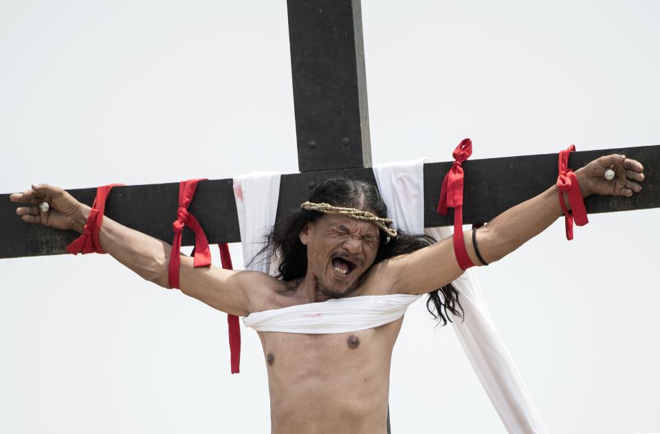 La reacción de Rubén Enaje cuando lo clavan en una cruz durante una recreación de la crucifixión de Jesucristo durante las celebraciones del Viernes Santo antes de la Pascua en el pueblo de Cutud cerca de San Fernando, al norte de Manila. (NOEL CELIS/AFP vía Getty Images)