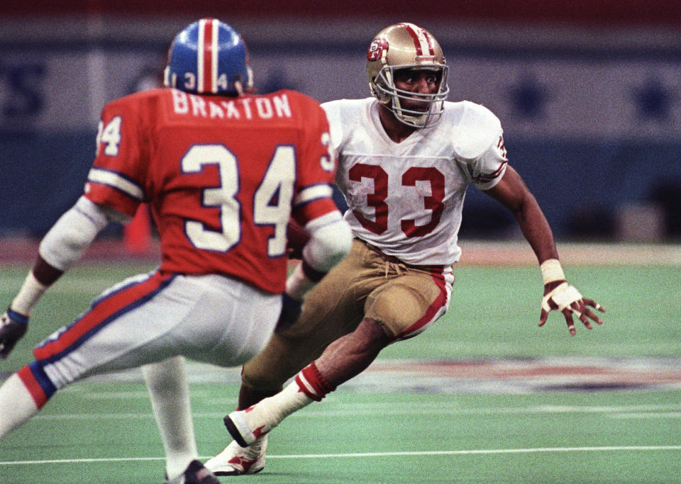 Jan 28, 1990; New Orleans, LA, USA; FILE PHOTO; San Francisco 49ers running back Roger Craig (33) carries the ball against Denver Broncos cornerback Tyrone Braxton (34) during Super Bowl XXIV at the Superdome. The 49ers defeated the Broncos 55-10. Mandatory Credit: Darr Beiser-USA TODAY Sports