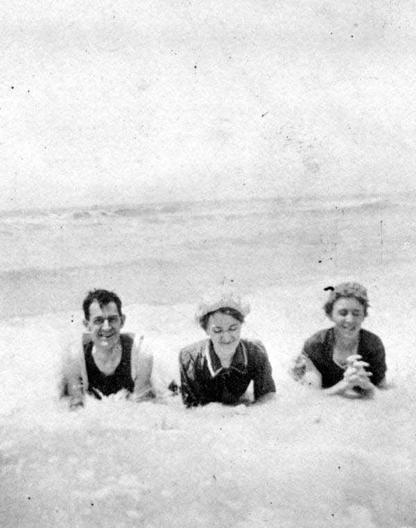 From left to right, Boyd Clifton Foxworthy, Alice Glascock and his wife, Mary, laying on Fort Myers Beach (1910 circa).