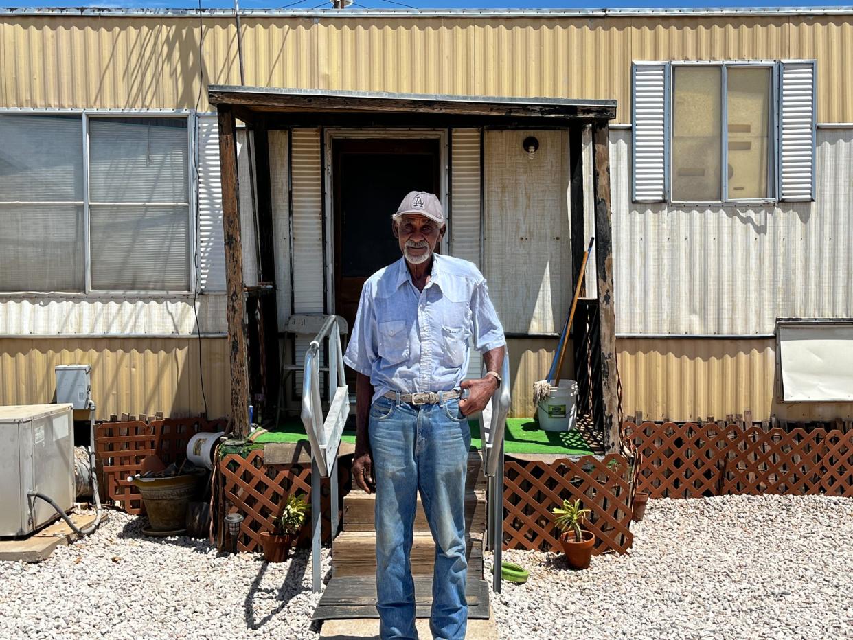Elmo Dees, 74, poses in front of his house on his family's property near Yuma on Aug. 7, 2022.