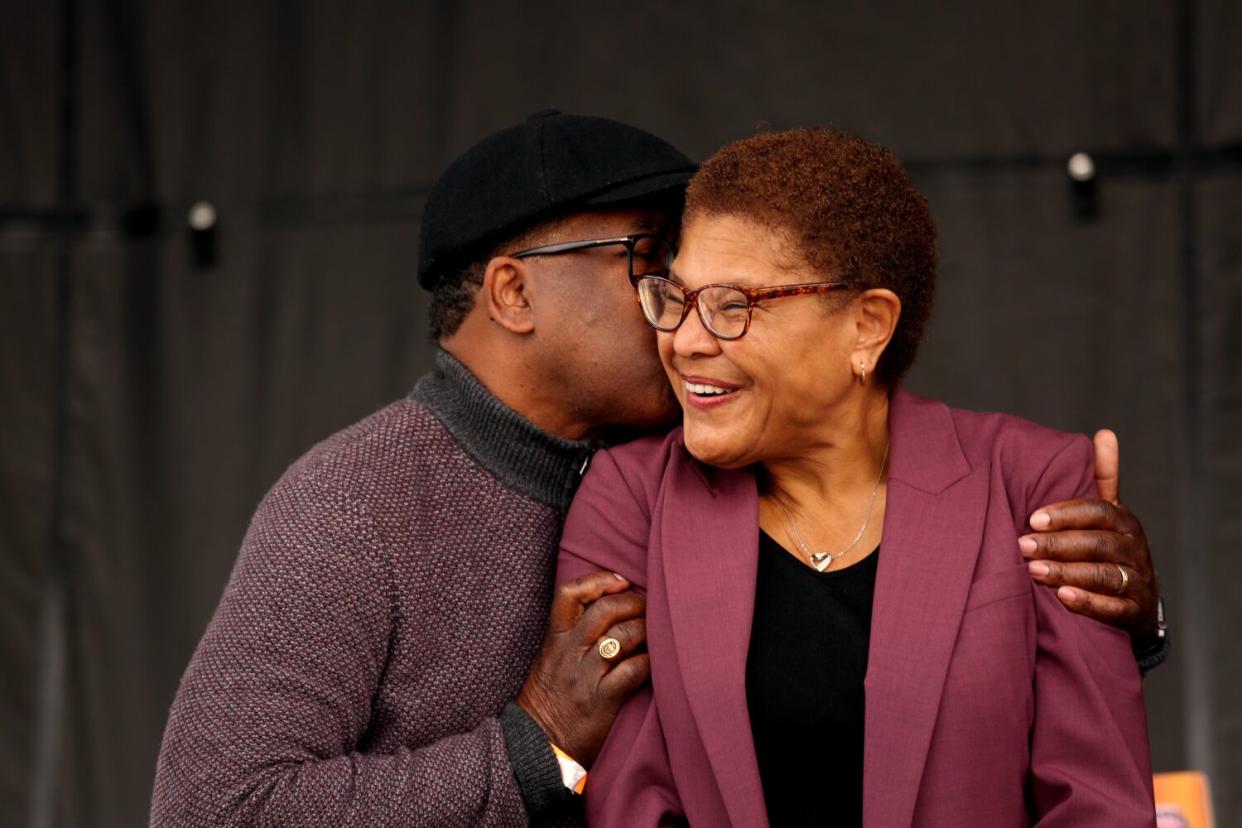 Suspended Los Angeles Councilman Mark Ridley-Thomas gives Los Angeles Mayor-elect Karen Bass a kiss of support