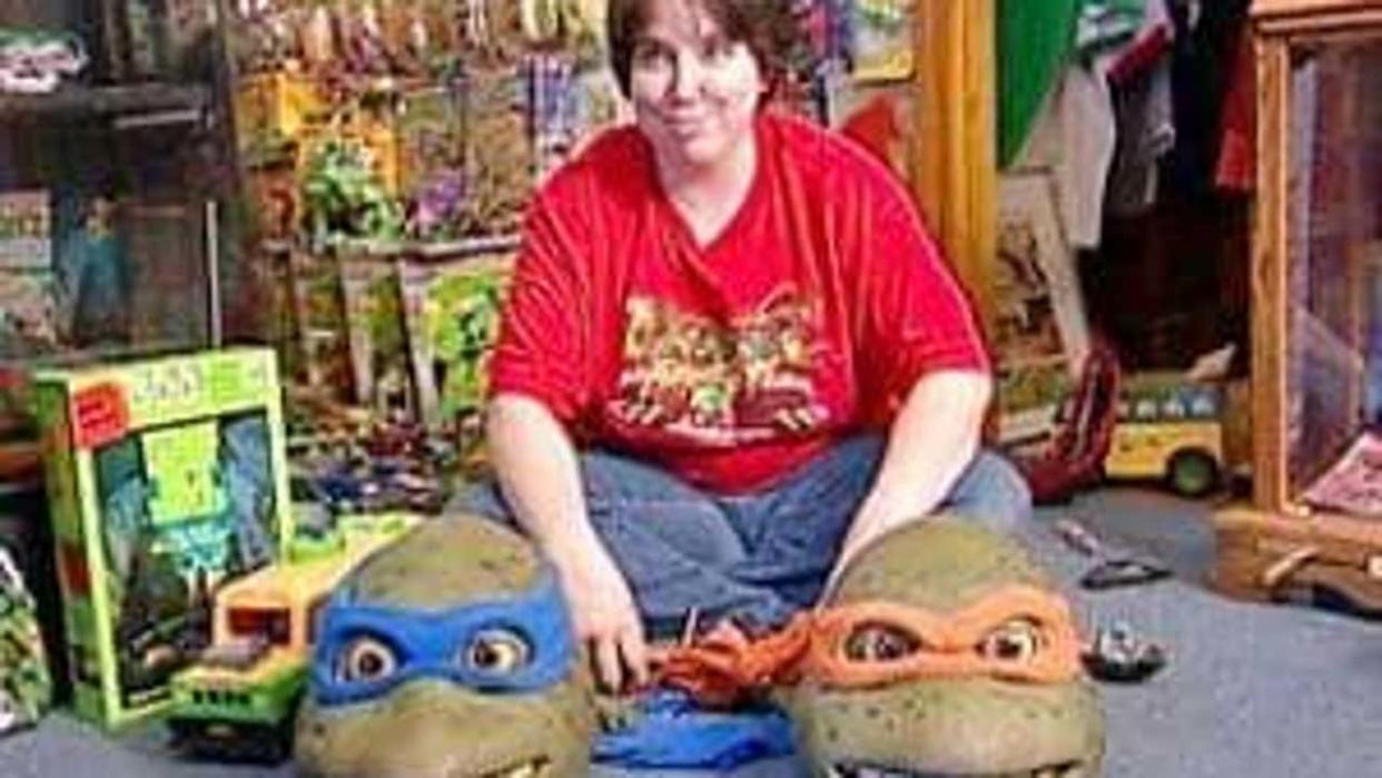 <div>Ninja Turtle superfan Michelle Ivey with some of her screen-used props from the live action movies. (Photo courtesy of Michelle Ivey)</div>
